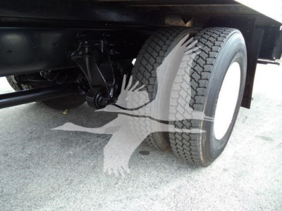 Truck rear axle showing dual rear wheels and suspension undercarriage of a 2019 International 4300 box truck.