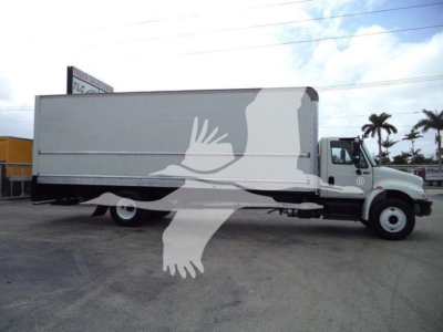 Medium-duty box truck side view showing cargo box with a large logo/watermark and a cab with International emblem; no legible model text visible.