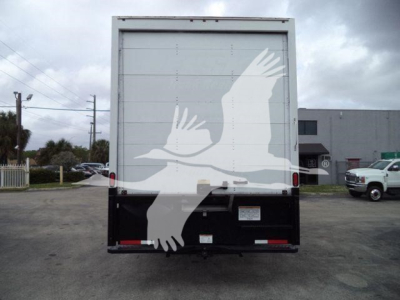 Truck rear showing large white bird decal on box, taillights and bumper visible.
