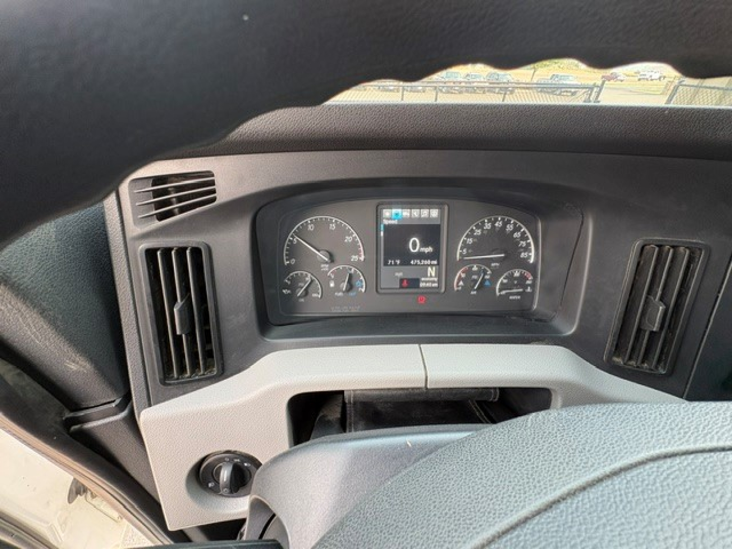 Dashboard view of a 2020 Freightliner Cascadia 126 showing instrument cluster and steering wheel with two vertical air vents.