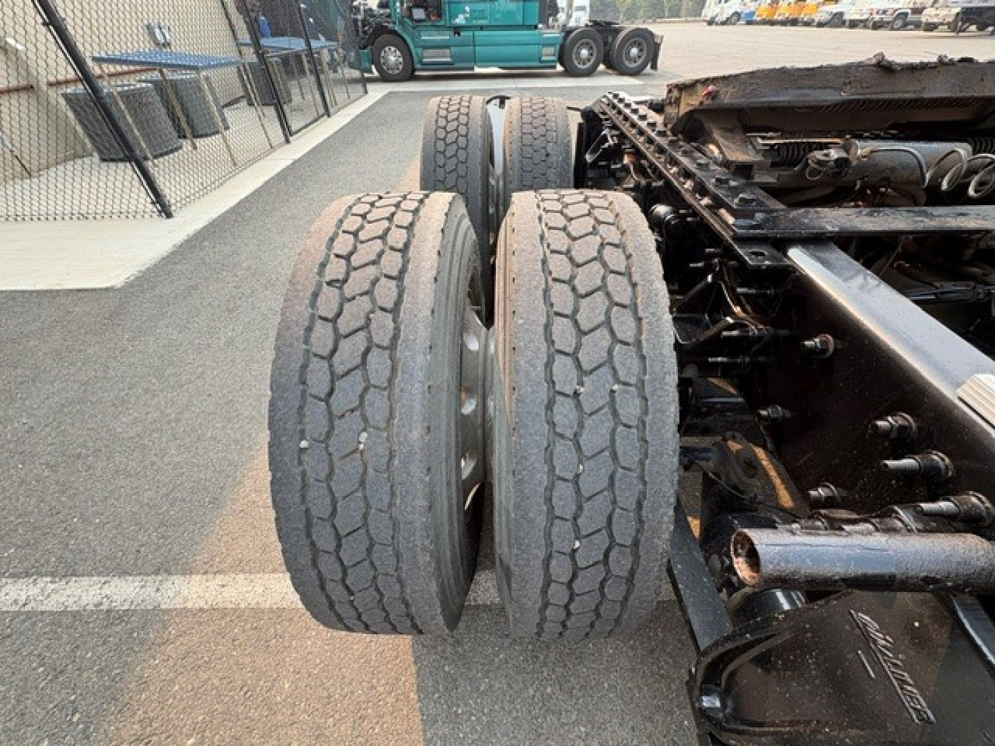 Freightliner Cascadia 126 truck chassis showing dual rear axles and suspension components.