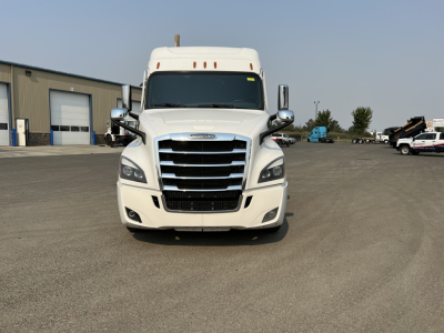 Freightliner Cascadia 126 sleeper tractor facing camera in a lot, front grille, headlights, and bumper visible.