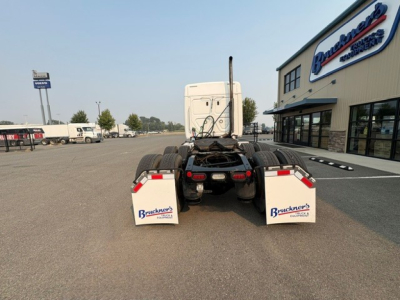 Rear view of a 2020 Freightliner Cascadia 126 tractor, show chassis and twin rear axles in lot near dealership