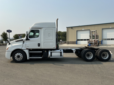 Truck cab and chassis of a 2020 Freightliner Cascadia 126 with sleeper cab, side profile, VIN sticker visible on stock tag area.