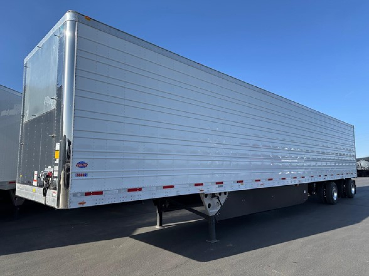 Trailer side view showing a new 2026 Utility 3000R refrigerated trailer with aluminum sides and a black undercarriage.