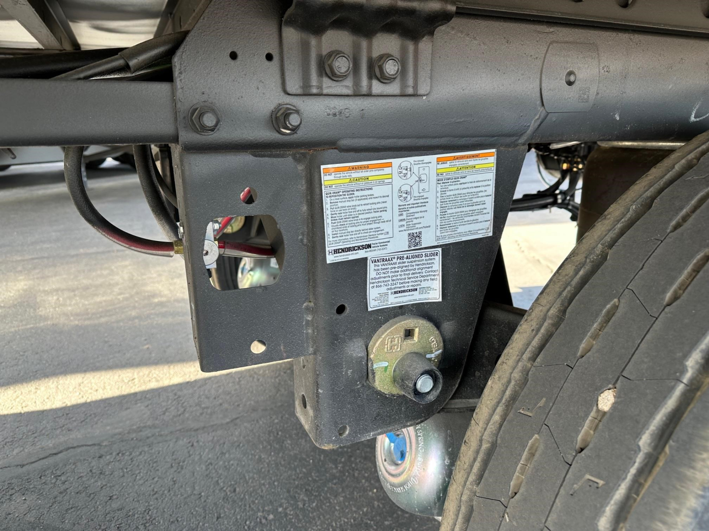 Trailer hitch area of a 2026 Utility 3000R reefer trailer showing near-side frame with stickered information plate and hitch mechanism.