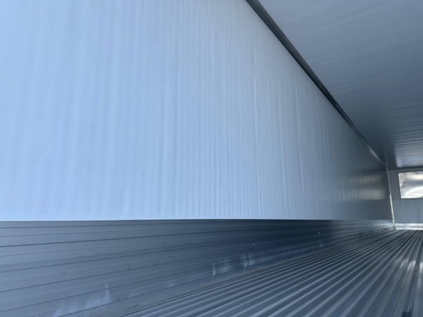 Trailer interior showing corrugated metal walls and empty cargo area of a 2026 Utility 3000R trailer.