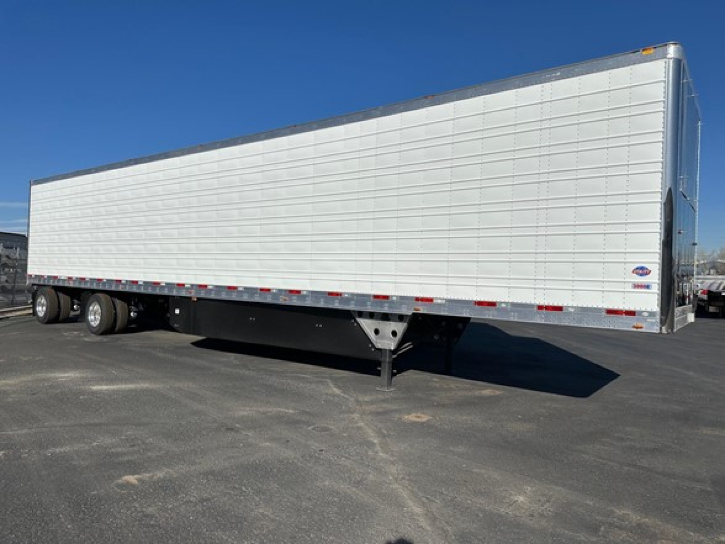 Trailer side view showing 2026 Utility 3000R refrigerated trailer with silver corrugated sides and dual rear wheels.