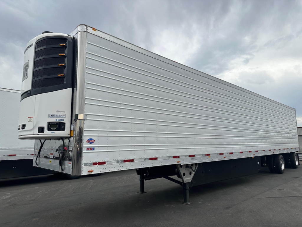 Trailer side view of a 2026 Utility 3000R reefer trailer with white exterior and rear refrigeration unit.