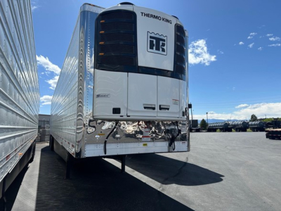 Front view of a Thermo King reefer trailer with white body and black front unit; visible are the truck refrigeration unit and reflective bumper area on the front of the trailer.