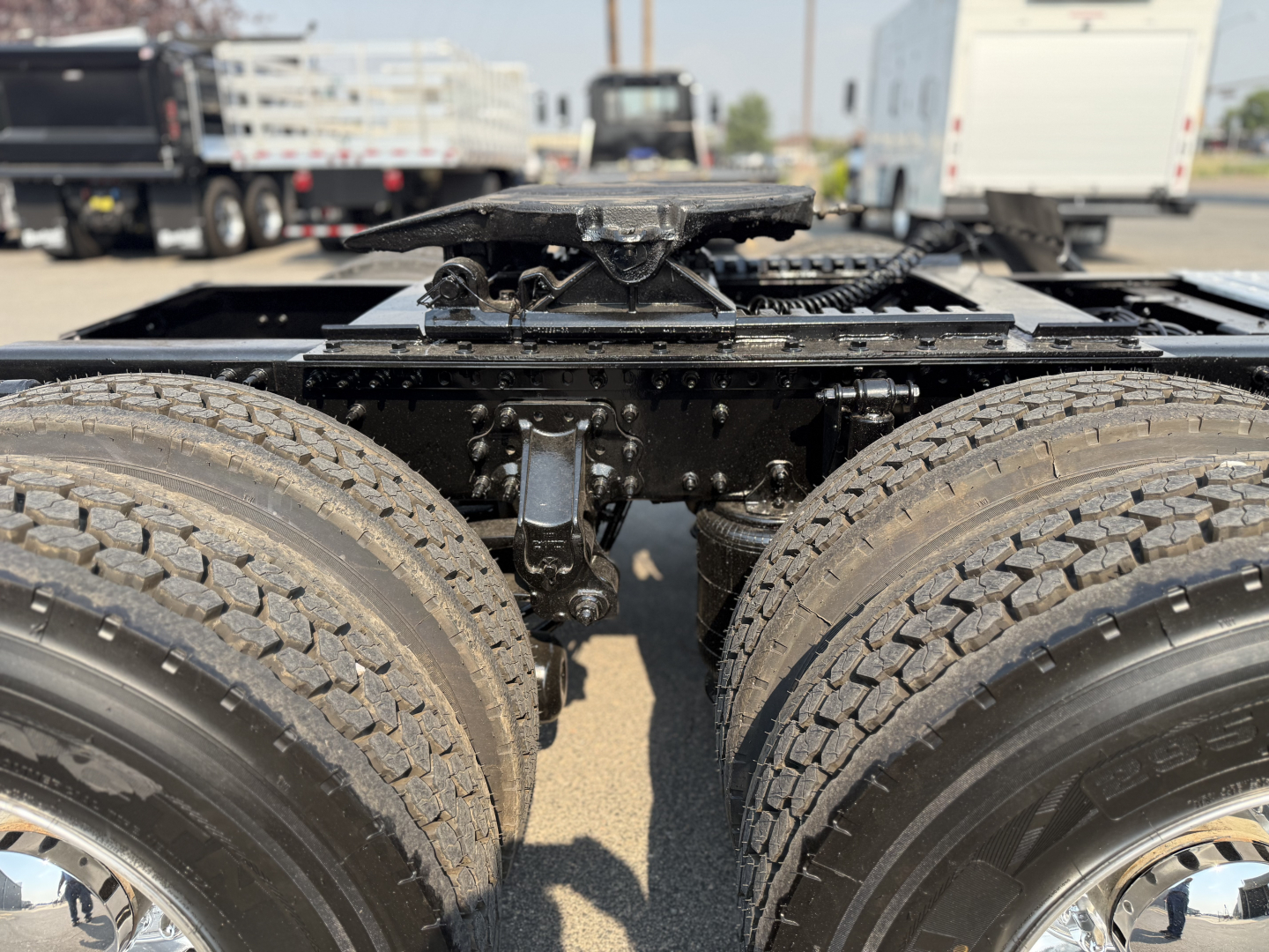 Mack AN64T rear chassis showing dual rear axles and air suspension components with frame and drivetrain visible.