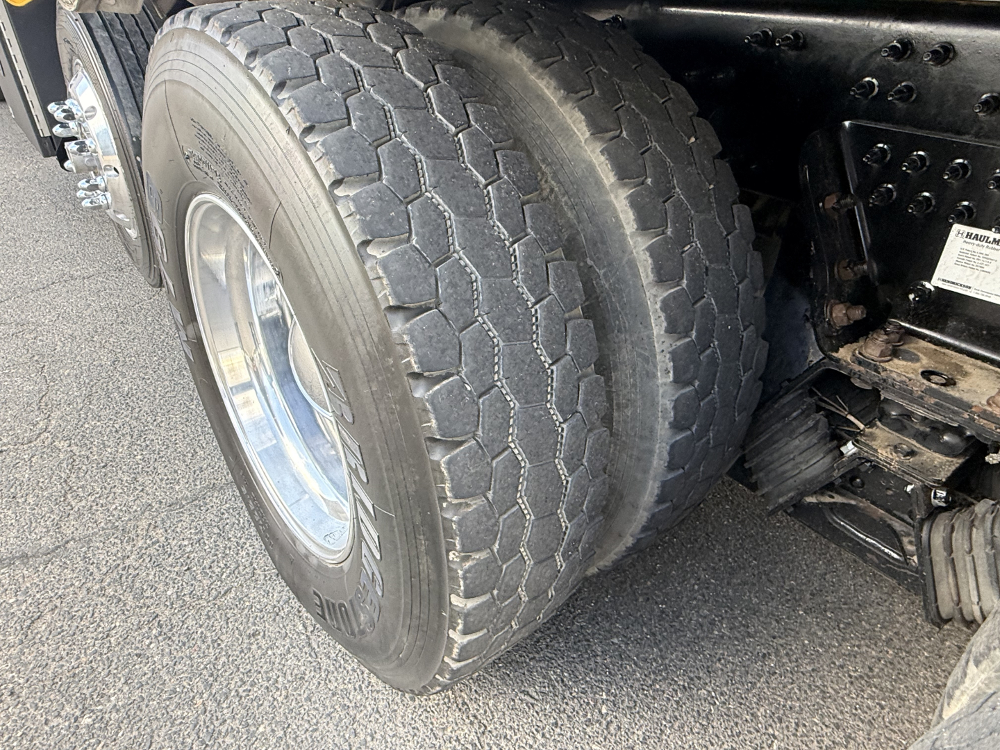 Truck rear wheel and dual-tire setup of a 2023 Mack GR64B showing tread pattern and wheel rims.