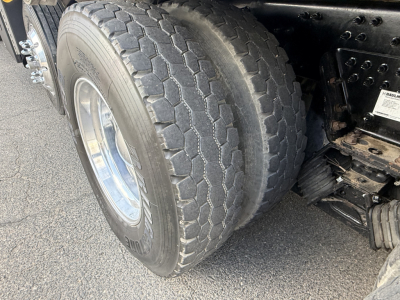 Truck rear wheel and dual-tire setup of a 2023 Mack GR64B showing tread pattern and wheel rims.