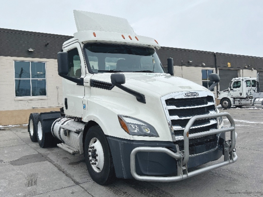 Freightliner Cascadia126 daycab truck in white with front bull bar and distinctive grille, side mirrors, and dual rear axles visible.