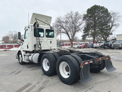 Truck cab of a 2019 Freightliner Cascadia126 with chassis and rear dual-axle configuration in a parking lot.