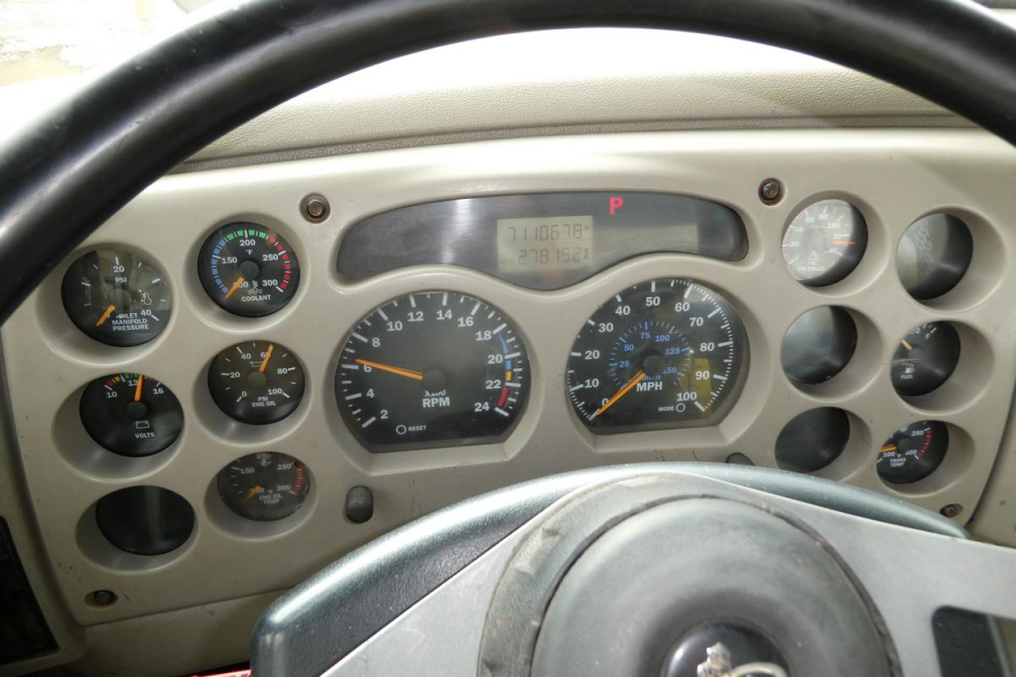 Dashboard of a Mack CX truck showing gauges and digital display with various indicators.