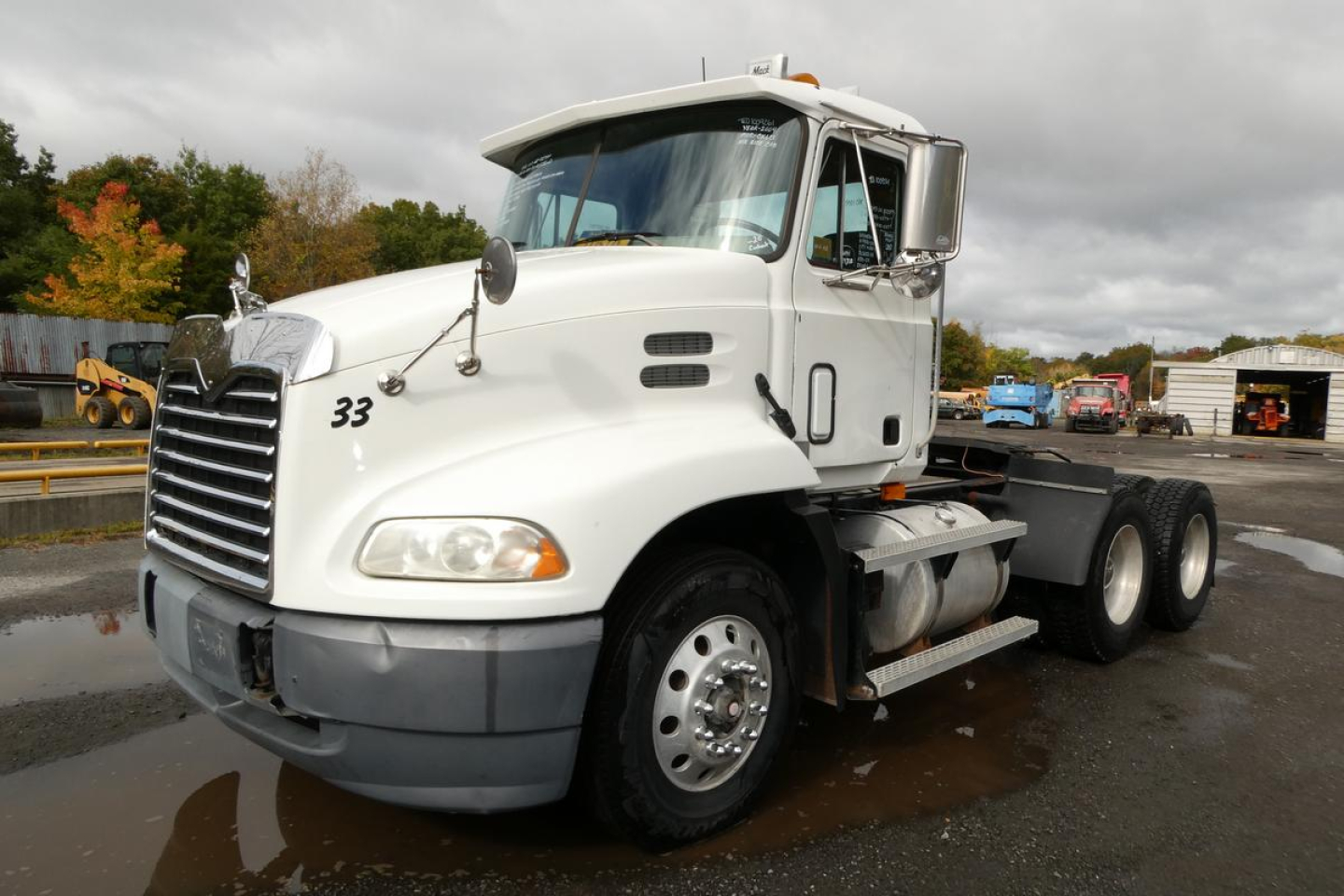 Mack CX613 Vision daycab tractor front-left view showing grille and headlights.