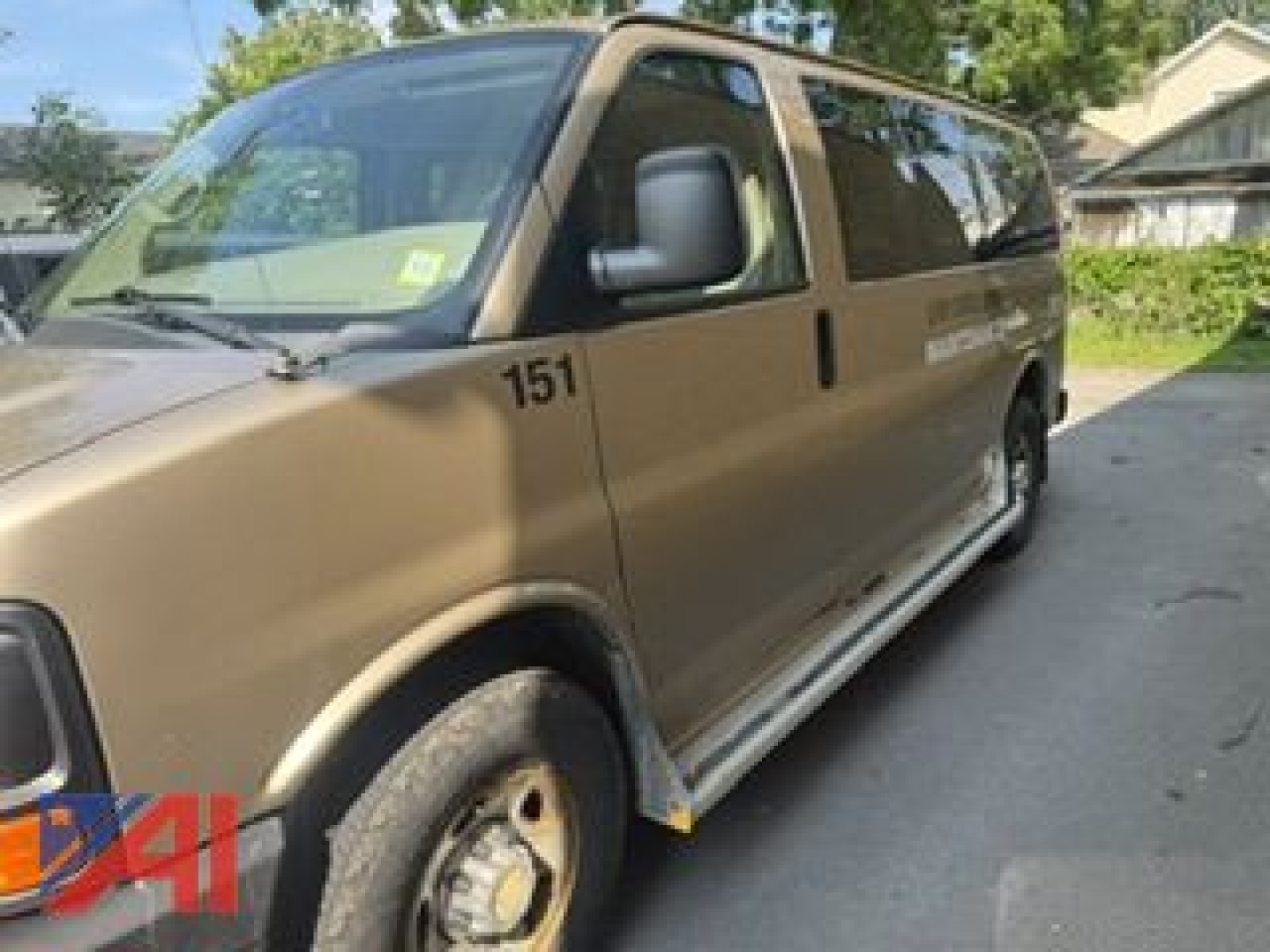 Chevrolet Express LS2500 cargo van side view showing 151 decal and beige paint.