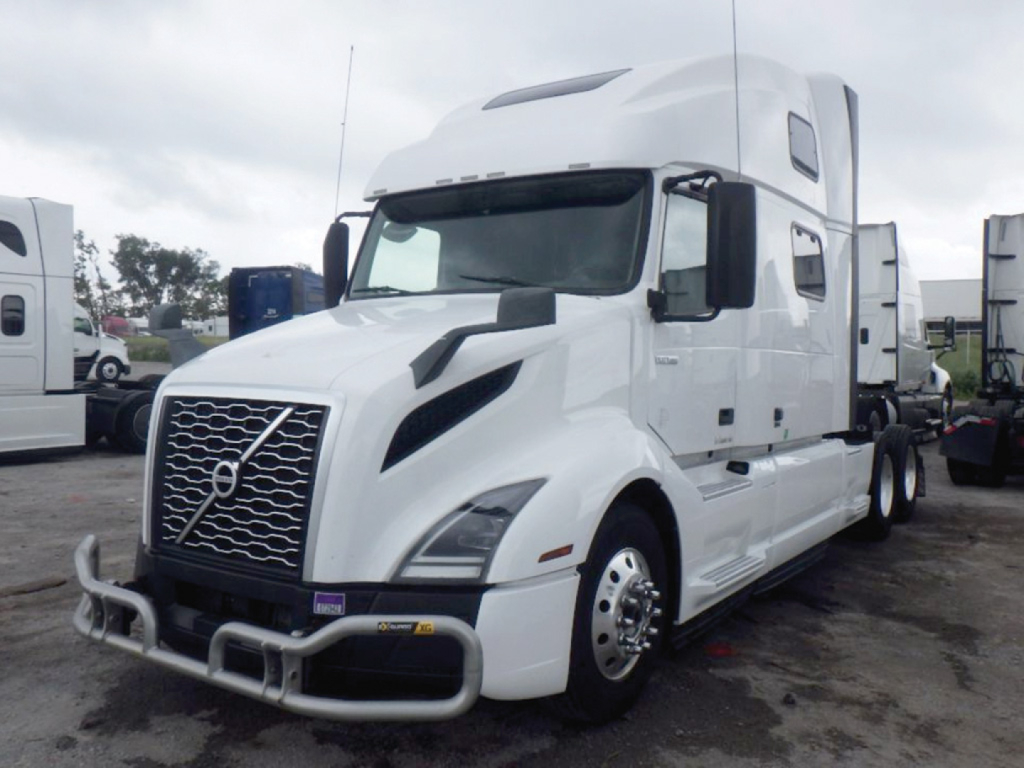 Volvo VNL 860 sleeper cab truck in white, front grille with Volvo emblem, large bumper guards, and side mirrors.