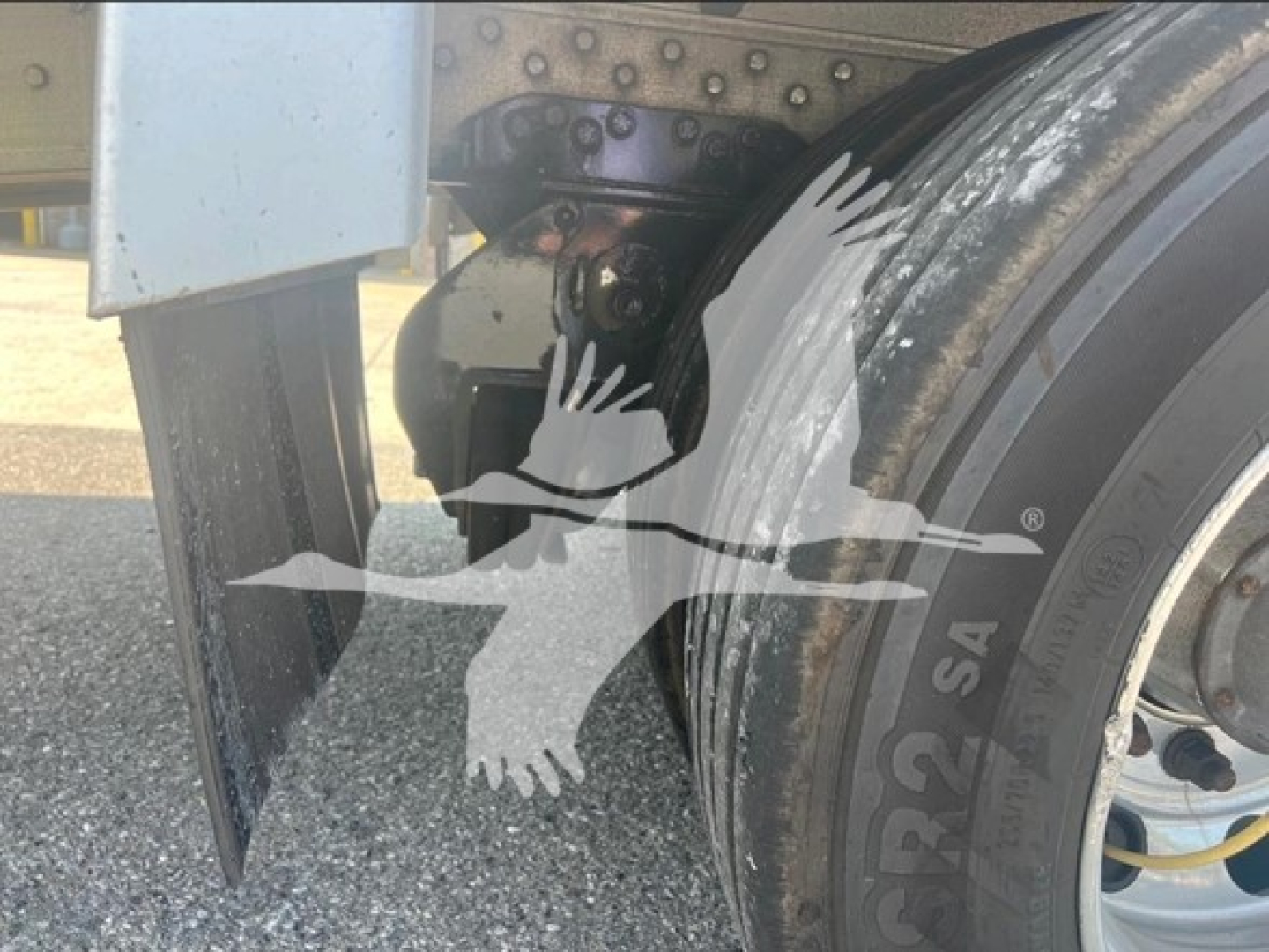 Trailer hub and deck area showing wheel, tire, and underside components of a dropdeck trailer. Visible text on tire: '275/80 R22.5' and some paint and metal surfaces.