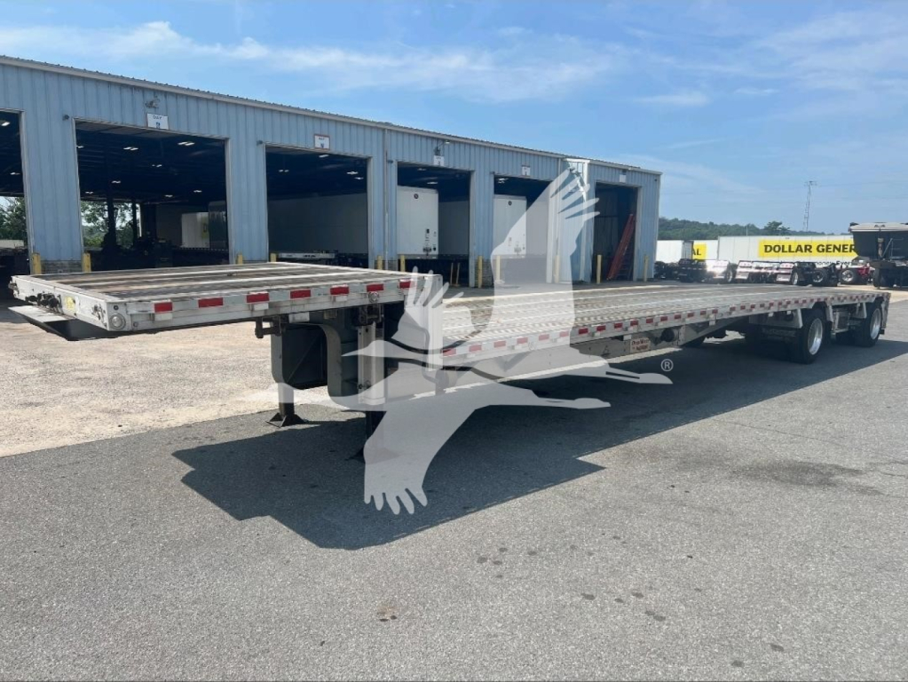 Trailer deck showing 2021 Reitnouer dropdeck trailer with long flatbed sections and tandem axles, VIN 1RND48A22MR055343, stock 7251.