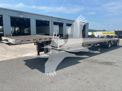 Dropdeck trailer in side view showing flatbed with gooseneck area, dual rear axles, and reflective tape along rails.