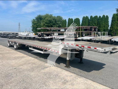 Trailer deck showing a dropdeck trailer with an elevated ramp, flatbed sections, and support legs. Visible text includes stock number 7251 and VIN 1RND48A22MR055343.