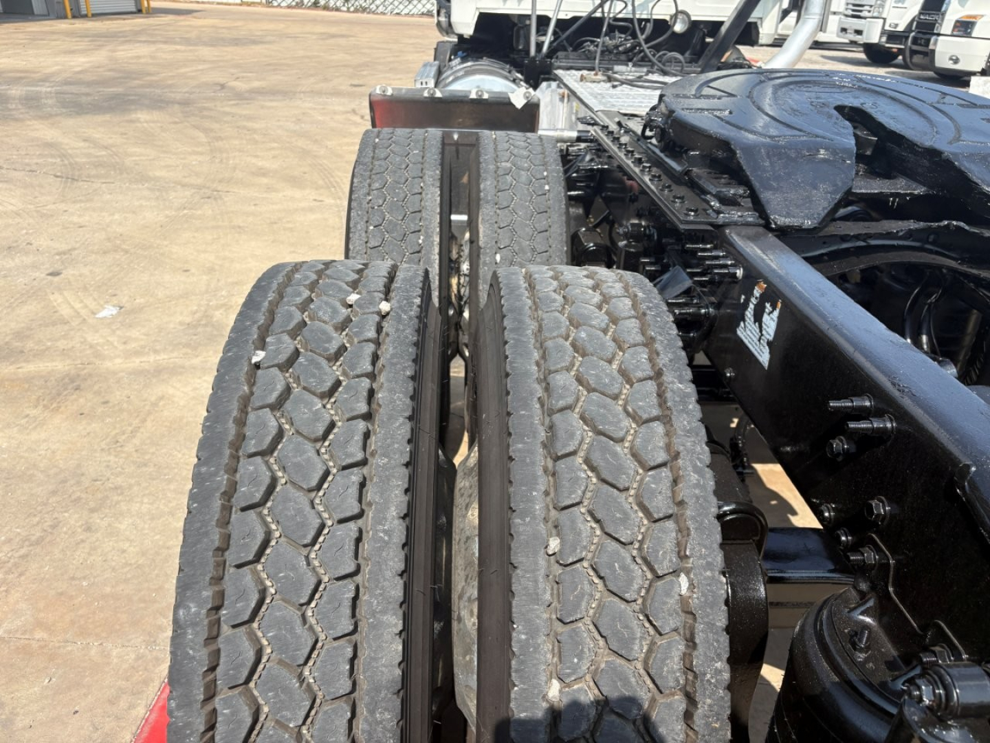 Two rear dual tires on a Mack PI64T tractor chassis showing tread wear and dual wheel setup.