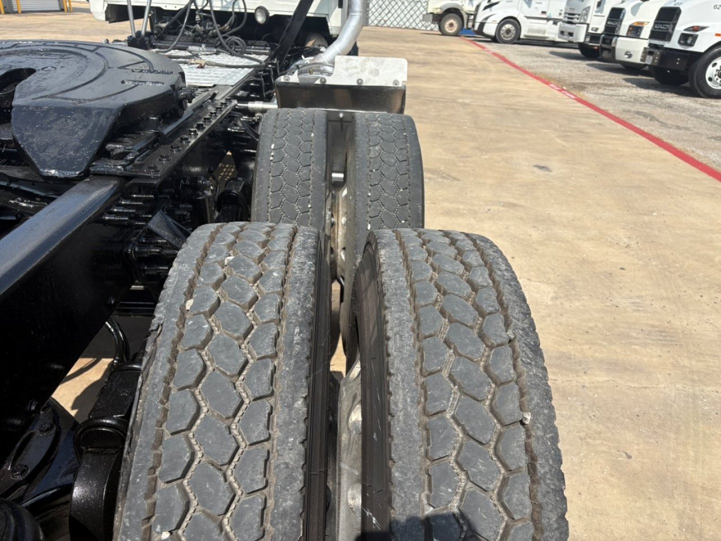 Dual rear tires on the drive axle of a Mack PI64T truck chassis with visible tread blocks