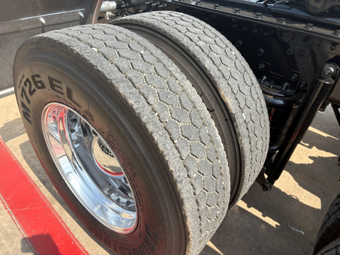 Mack PI64T wheel and dual rear tires with chrome rims and tire tread visible