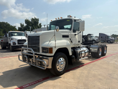 Truck shown from front-left angle with large grille, bumper guard, and dual rear axles. Exterior white cab, chrome wheels, and fuel tanks visible. No legible text identified in image.