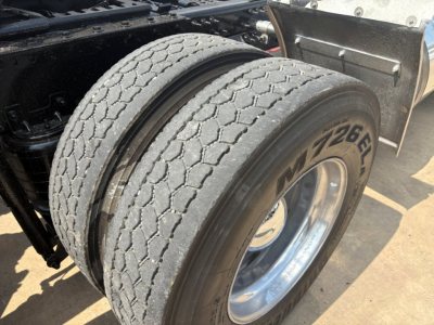 Mack PI64T truck dual rear tires showing tread and wheel rim.