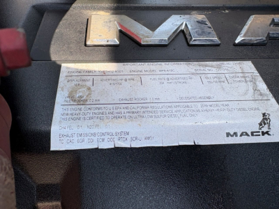 Mack PI64T engine bay label plate with Mack logo and engine information sticker.