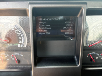 Vehicle totals screen on Mack PI64T showing mileage, engine hours, fuel used, and RPM data in center dash display.