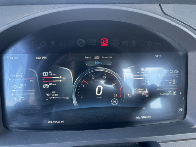 Dashboard display of a 2022 Kenworth T680 showing digital gauge cluster with 0 MPH in the center, fuel, DEF, oil, and coolant indicators; odometer 163,855.0 MI, trip 546.8 MI, time 1:10 PM, ambient 74F.