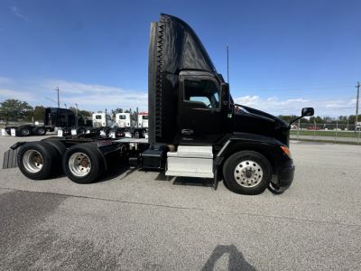 Kenworth T680 tractor unit side view showing cab with tall sleeper fairing and black paint, side steps, fuel tanks, and rear wheels; text on the truck not legible.
