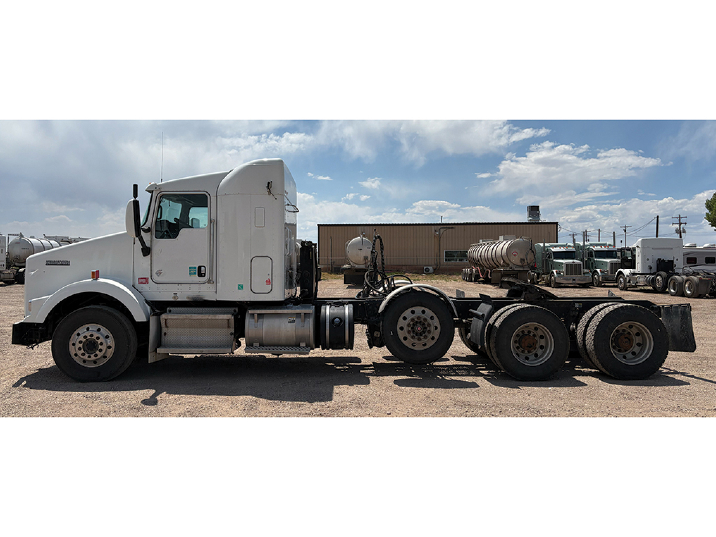 Kenworth T-800 AeroCab tractor in side profile showing sleeper cab, chassis, six rear axles, and fuel tanks with attached equipment.