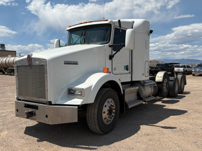 Kenworth T-800 AeroCab conventional sleeper truck front view showing grille, hood, and dual rear axles in white paint.