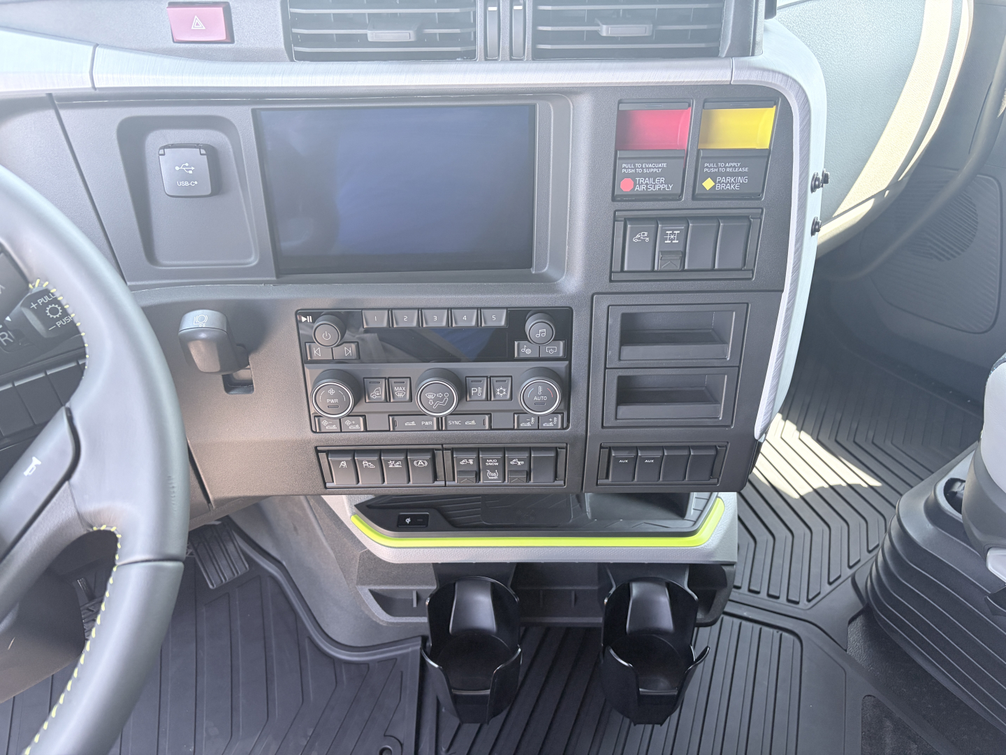 Truck dashboard interior showing center console with climate controls, radio area, and storage compartments.