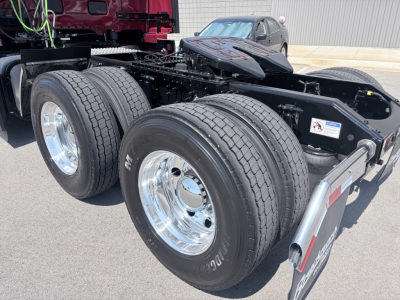 Volvo VNL64T860 tractor rear showing dual rear axles with large dual tires and chrome wheels, chassis, and fifth wheel connection area.