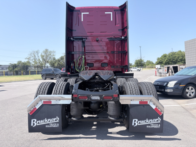 Volvo VNL64T860 tractor rear view showing fifth wheel area, dual rear axles, mud flaps with Bruckner’s Truck & Equipment logos, and wiring harnesses on the back of the cab.