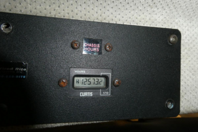 Truck instrument panel showing a CURTIS hour meter reading 125,732 hours mounted on a black panel.