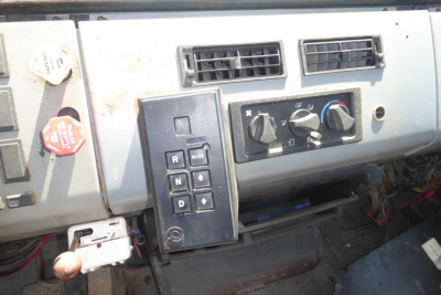 Dashboard of a Freightliner truck showing climate controls and gear selector panel with R N D P and arrow keys, mid-2000s style.