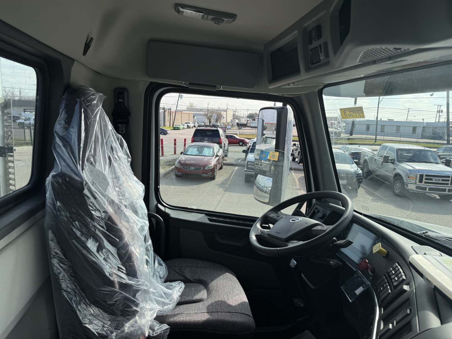 Volvo VHD64FT300 cab interior showing steering wheel and dashboard.