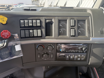 Dashboard of Volvo VHD truck cab showing switch panel, gauges, steering column area, and radio with CD slot.