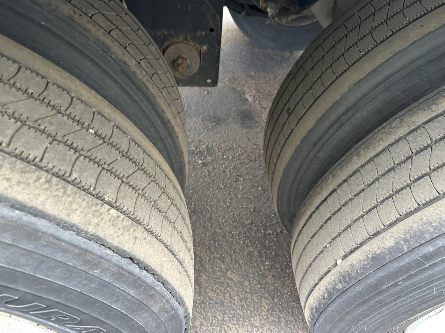 Double axle trailer tires and chassis view under a 2017 Utility 4000D-X trailer showing dual tires and frame clearance.