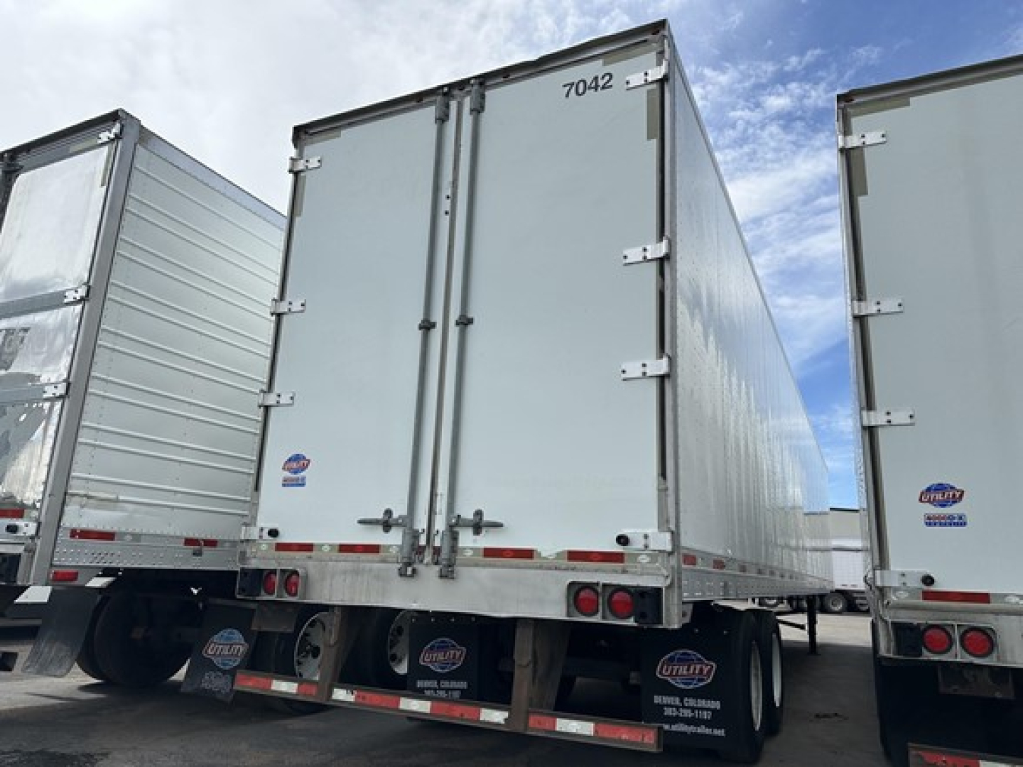 Trailer rear view showing two closed doors on a 2017 Utility 4000D-X trailer with wheels and undercarriage visible.