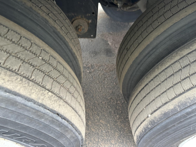 Double axle trailer tires and chassis view under a 2017 Utility 4000D-X trailer showing dual tires and frame clearance.