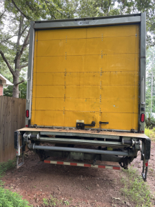  Freightliner M2 106 box truck rear view showing yellow cargo door and rear underrun guard
