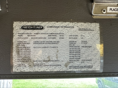 Freightliner M2 106 component information plate mounted on underbody showing model, serial, and specifications text.